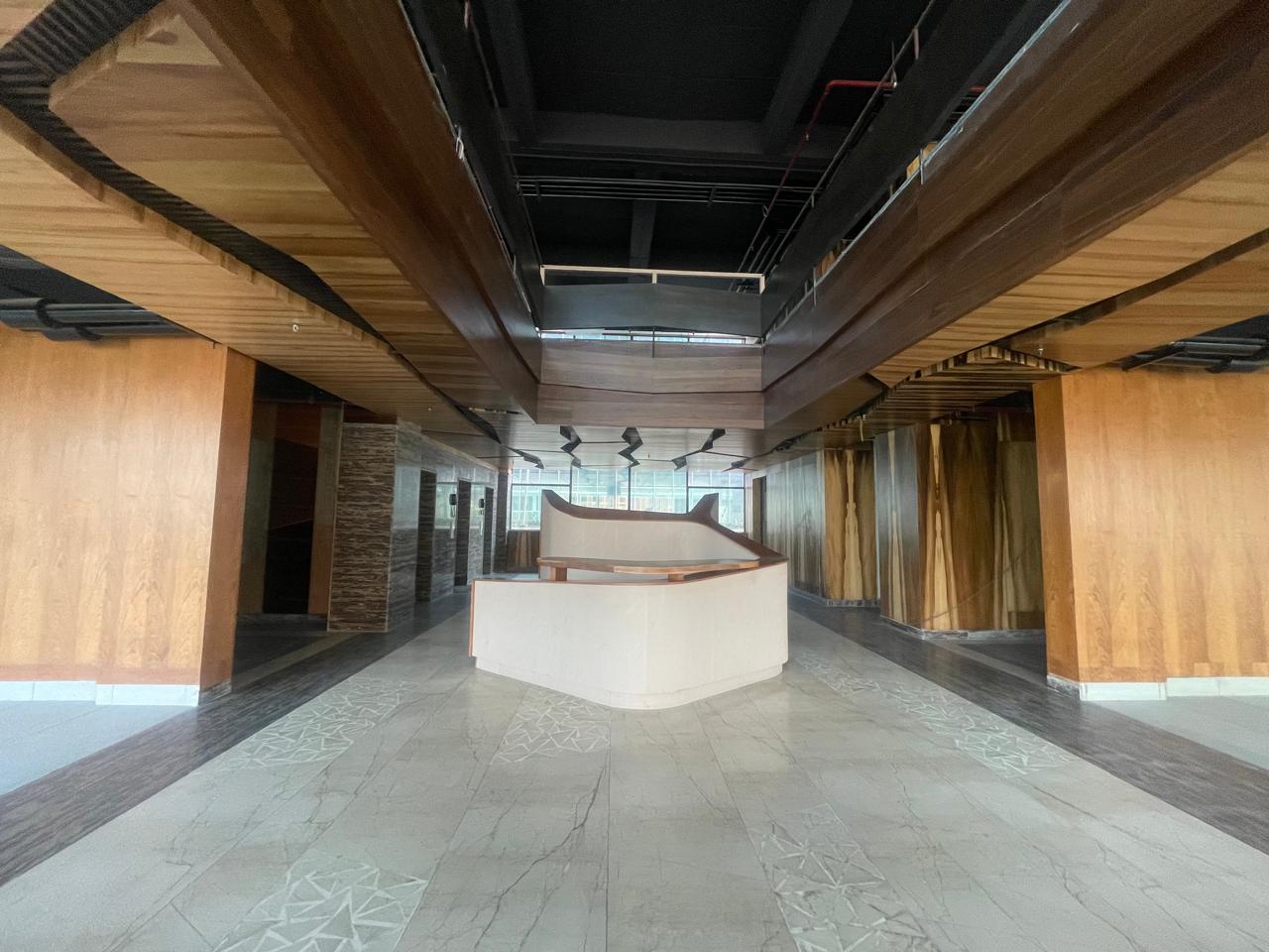 Grand lobby with double-height ceiling and wood paneling — Grade A Office Space, Sector 136 Noida
