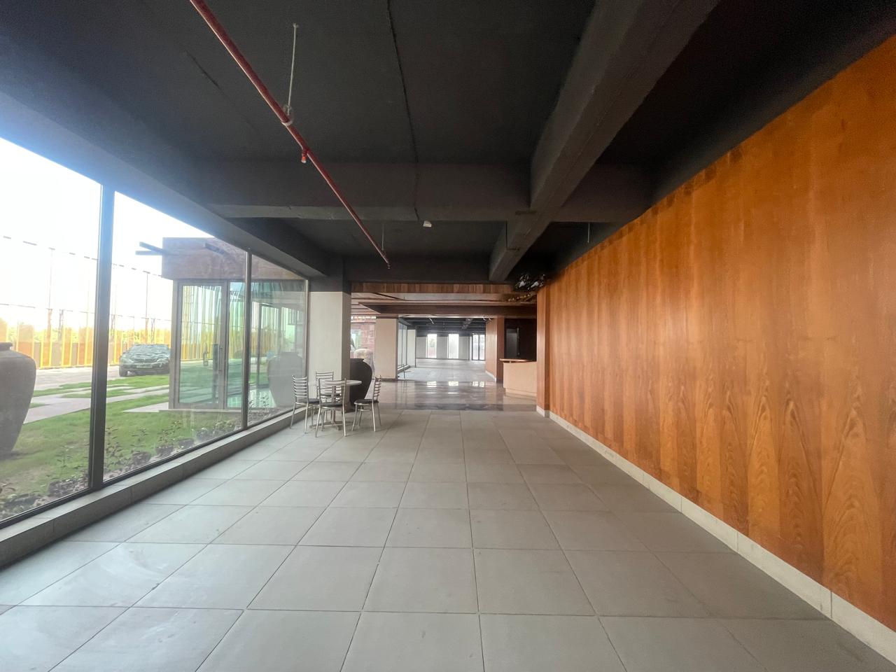 Building exterior with landscaped garden frontage — corporate office lease Noida
